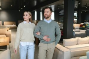 Attractive woman with her husband at the furniture store showroom